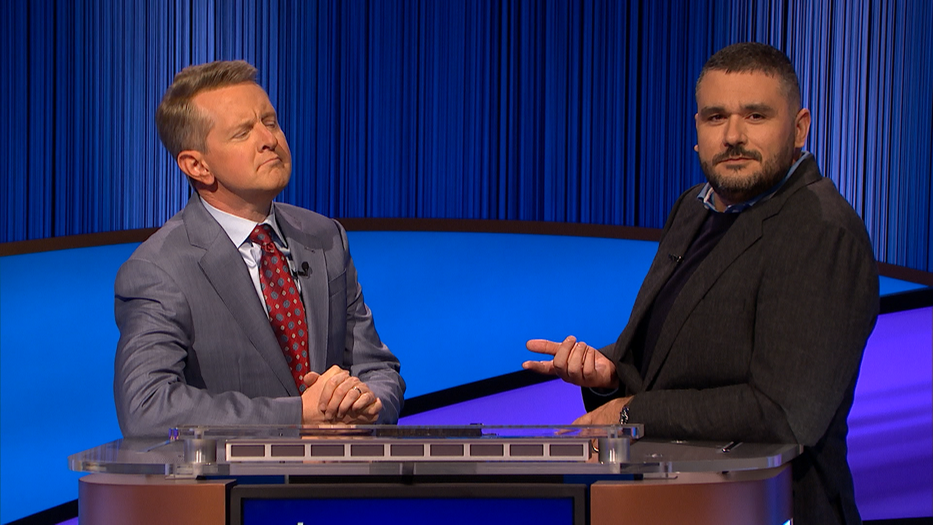 Donesh Olyaie on the Jeopardy! set, mid-conversation with host Ken Jennings at the podium
